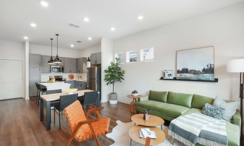 Open-concept living area with modern furniture and kitchen island
